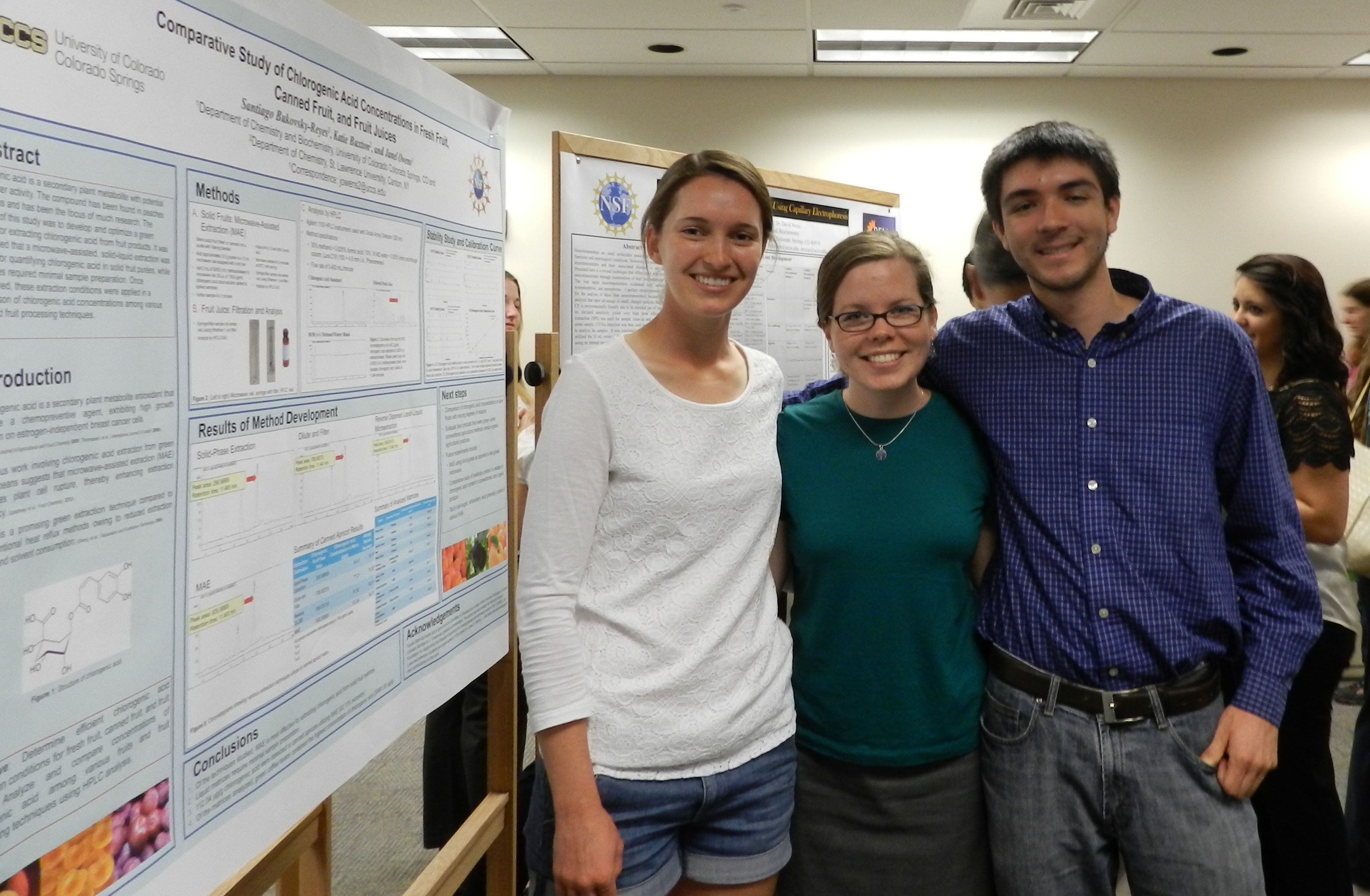 Faculty and student researchers with poster