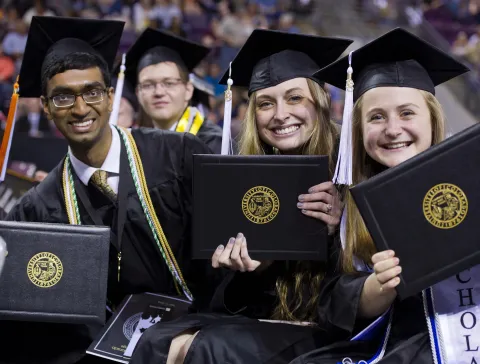 students smiling at graduation