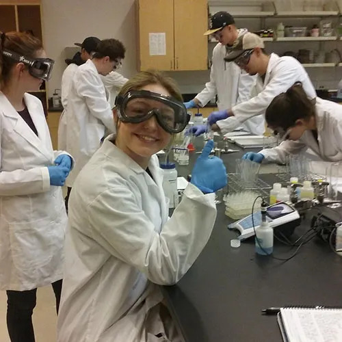 Student smiling during chemistry lab