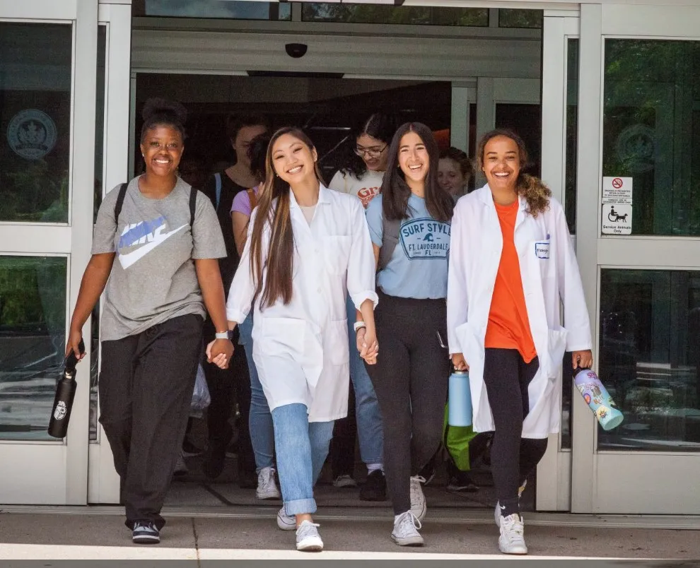 High school students leaving UCCS building in lab coats